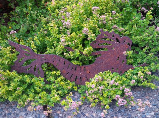 oxidized mermaid on bed of herbs